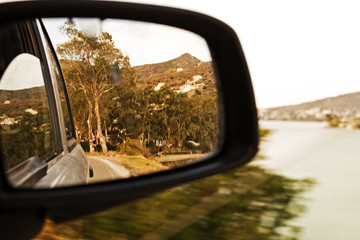 right side mirror in the car near the sea