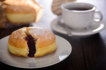 Berliner donut with berry jam. Close up