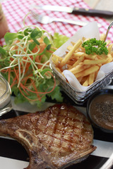 Top View Grilled steaks and vegetable salad. Steak porkchopblackpepper.