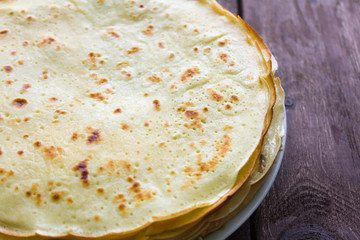 homemade freshly baked pancakes on wooden background
