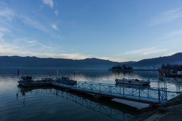 Last evening light reflecting in the calm waters of the Danube as it reaches the Romanian town of Orsova