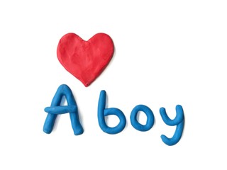 Red heart and A boy text made from plasticine clay dough on white background