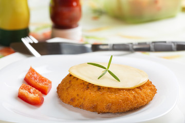 Chicken cordon Bleu on plate with one slice of cheese on top
