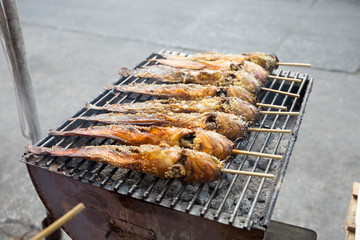 Roasted catfish with garlic on a barbecue grill, Petburi road, Bangkok, Thailand