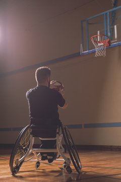 Disabled man practicing basketball in the court
