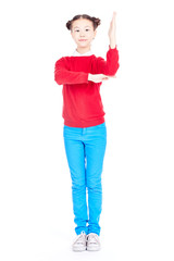 Portrait of cute Asian school girl in red sweater and blue jeans with double buns on her head posing on white background