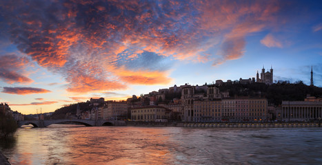 High water levels in the Saone river during a colorful dusk at Quai des Celestins. Lyon, France.