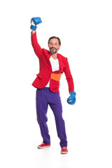 Male boxer in colorful clothes. Raising one hand and smiling.