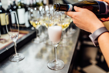waiter brings glasses of champagne