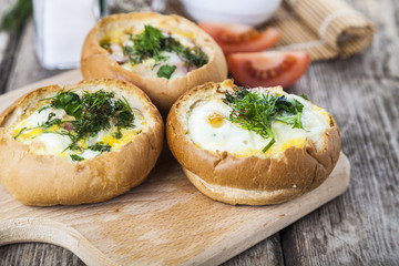 Scrambled eggs with bacon in a bun.