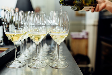 waiter brings glasses of champagne