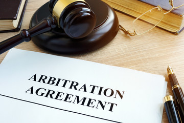 Arbitration agreement resolution of commercial disputes on a desk.