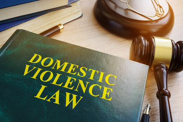 Domestic violence law on a wooden table. - obrazy, fototapety, plakaty