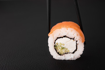 closeup photo of one sushi roll with salmon