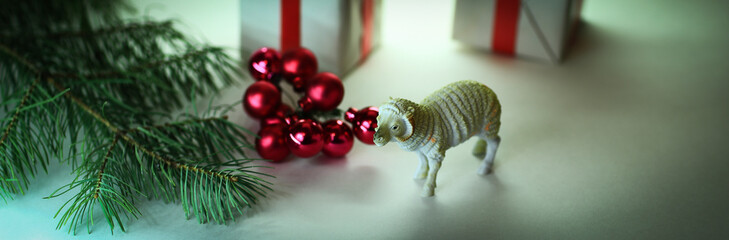 Obraz na płótnie Canvas red Christmas balls , gifts and toy lamb.