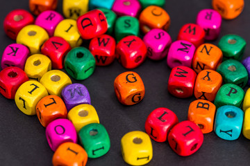 Color wooden cubes isolated on black