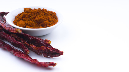Red Chilly Powder in a bowl on white background. Selective focus and crop fragment.
