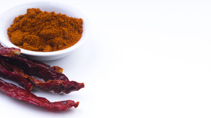 Red Chilly Powder in a bowl on white background. Selective focus and crop fragment.
