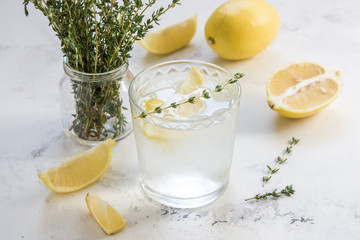 Detox water with lemon and thyme in glass