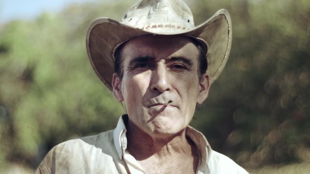 Farmer smoking a handmade cigar. Simple man. Country man