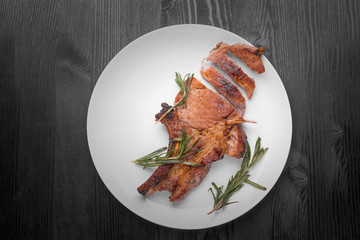 steak pork on a plate with rosemary