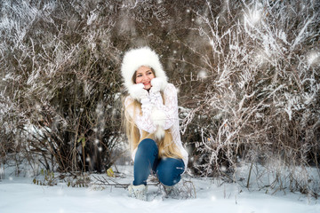 Outdoor fashion portrait of pretty young woman in winter forest