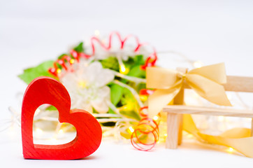 wooden heart with a bow on a bench on a white background. Valentine's Day