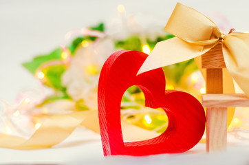 wooden heart with a bow on a bench on a white background. Valentine's Day