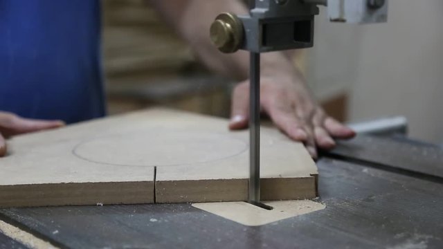 Cutting Wood in Carpenter Workshop with Table Circular Saw