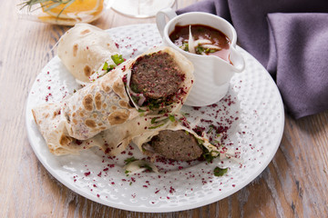 shish kebab in pita bread on a plate 