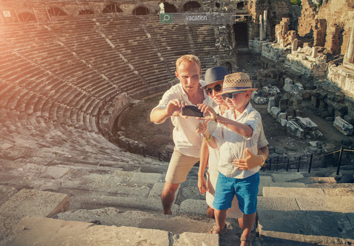 Family take vacation selfie photo on the antique theater ruins in Side, Turkey.