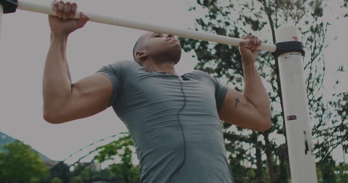 Black Male looking into Camera after doing pull up 
