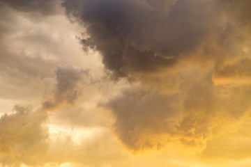 Storm clouds in the sky at sunset as background