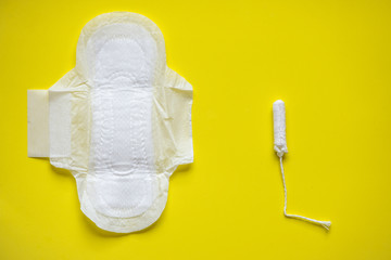 Feminine pad with wings and tampon