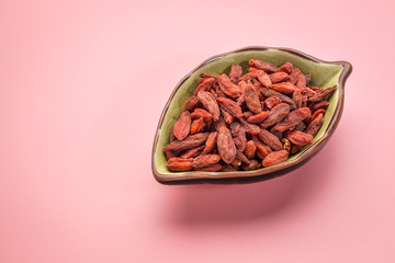  dried Tibetan goji berries in ceramic bowl