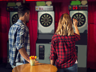 Young couple playing darts