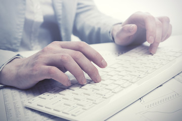 Business woman using computer keyboard in office