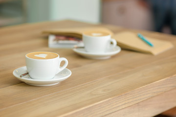A table setting for coffee on the counter at a coffee house