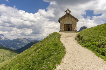 Fototapeta na wymiar A small church in the Dolomites. Viewpoint Passo Pordoi. Italy.