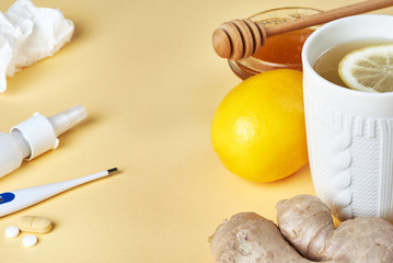 Fresh ginger root, lemon, honey, drags, cap of tea and thermometer