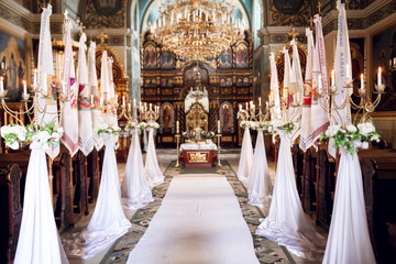 Interior of church with decoration for wedding with candels light