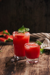 Refreshing summer watermelon juice in glasses with slices of watermelon