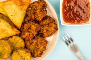 Selection of Indian Snacks Vegetarian Onion Bhaji Samosas and Tikka