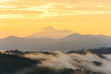 Mount Trusmadi and part of the Crocker Range in Sabah, Borneo with layers of foggy hills during sunrise