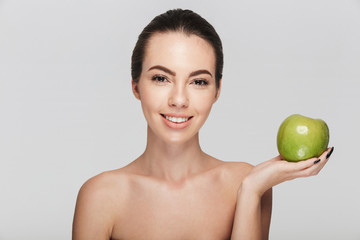 attractive young woman with fresh green apple isolated on white