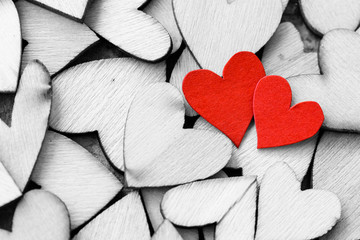 Obraz premium Vintage style of 2 red hearts with wooden hearts on a wooden background. Happy Valentine's Day concept.
