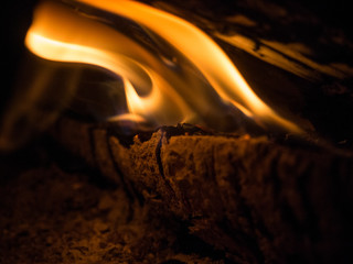 Burning woodfire in a fireplace on a black background