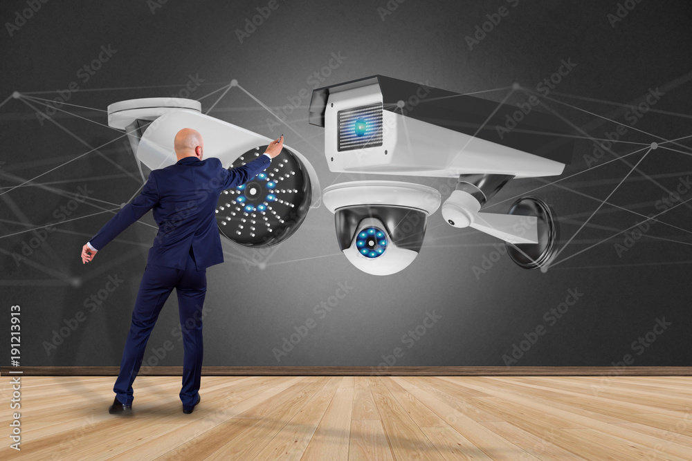 Poster businessman holding a security camera system and network connection - 3d rendering