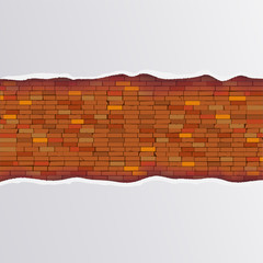 The white paper torn in the center under which is visible a brick wall and a shadow.