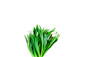 Spring bouquet of delicate pink tulips on white background top view copy space
